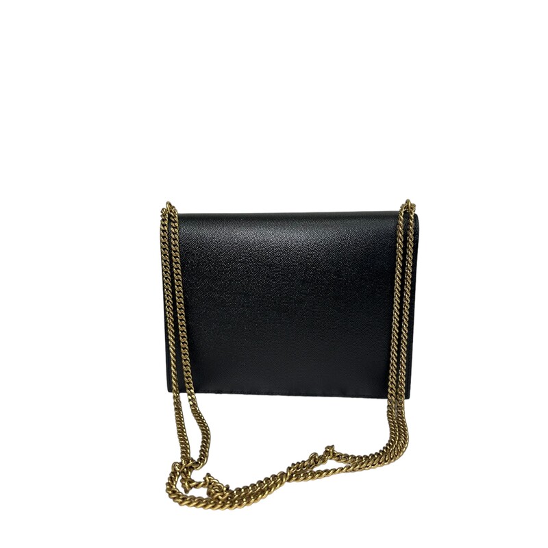 SAINT LAURENT Smooth Calfskin Monogram Cassandra Clasp Bag in Black. This elegant shoulder bag is crafted of smooth calfskin leather in black. The bag features aged gold chain link strap and a prominent YSL monogram twist-lock closure. This opens to a burgundy leather interior with zipper and patch pockets.<br />
Dimensions:<br />
Base length: 8.5 in<br />
Height: 6.5 in<br />
Width: 2 in<br />
Drop: 13 in<br />
Drop: 23.25 in<br />
<br />
Comes with box and dustbag