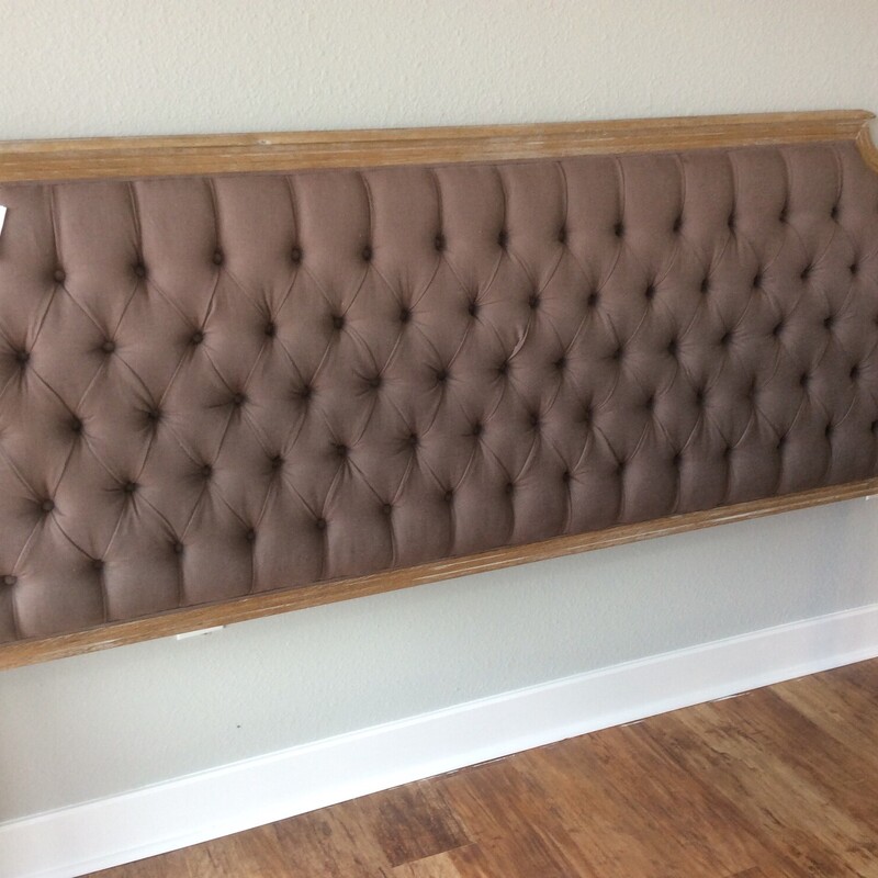 Tufted brown king headboard with metal frame.  King