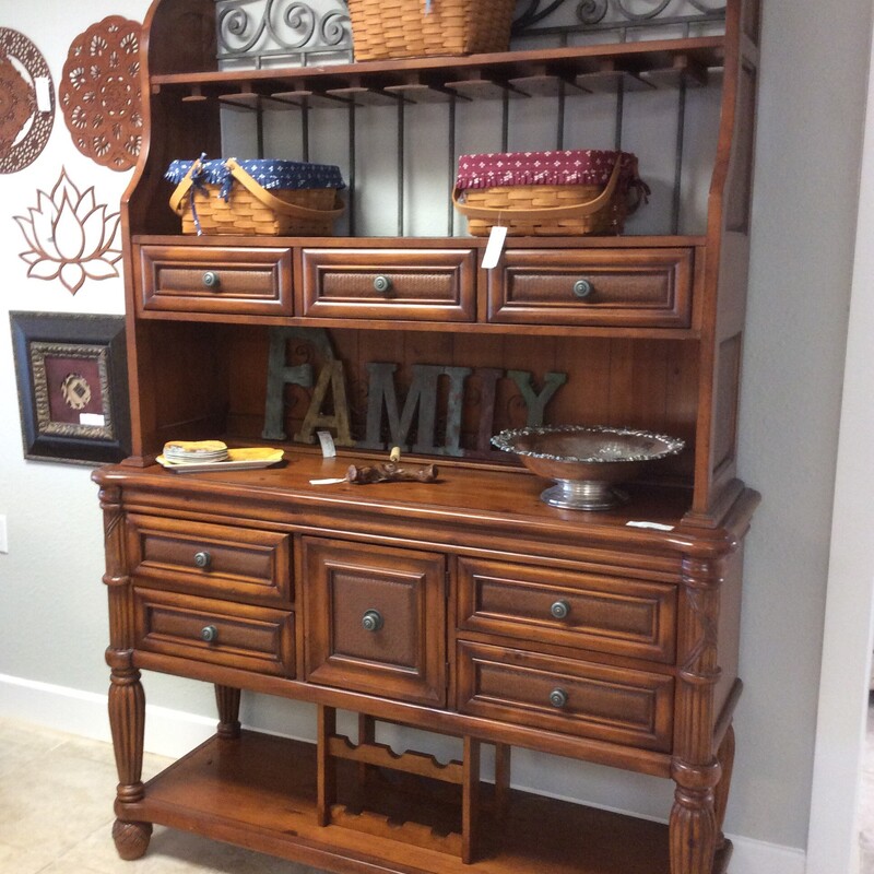 This is a very nice wine buffet hutch, a combination of metal and wood. It provides plenty of storage, has a dark wood finish and several drawers.