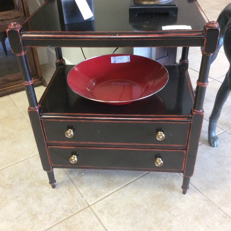 This chic little side table by Designer Theo Alexander has a black distressed finish with a red under coat.