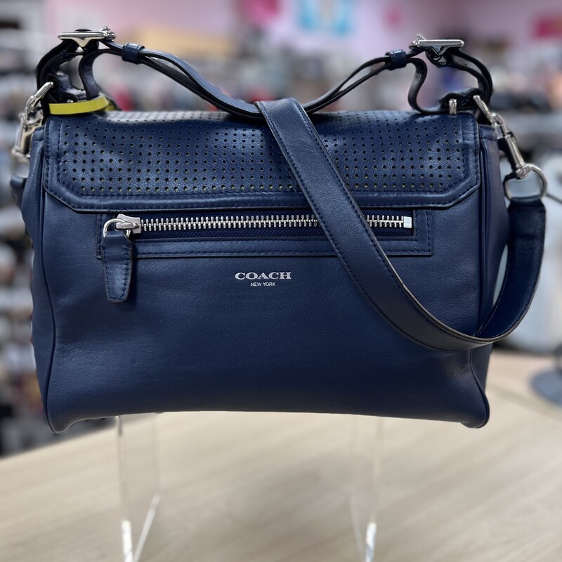 COACH<br />
Legacy Perforated Leather Romy Top Handle Bag<br />
Glovetanned leather<br />
Inside multifunction pockets<br />
Turnlock closure, twill lining<br />
Shoulder strap with 4 1/4\" drop<br />
Detachable strap with 19\" drop<br />
11 1/2\" (L) x 8 3/4\" (H) x 5\" (W)<br />
<br />
A soft and versatile flap style in vivid perforated leather, the latest Romy is a beautiful combination of luxury and functionality. Carry the tassel-trimmed design by the adjustable handle or wear it with the longer strap as a shoulder bag or crossbody.<br />
Perforated leather, Inside zip, cell phone and multifunction pockets, Turnlock closure, fabric lining, Longer strap for shoulder or crossbody wear. Comes with Original Dust Cover.<br />
<br />
Original Retail Price $458.00  This handbag is in excellent preowned condition.  In like new condition, no marks or flaws.