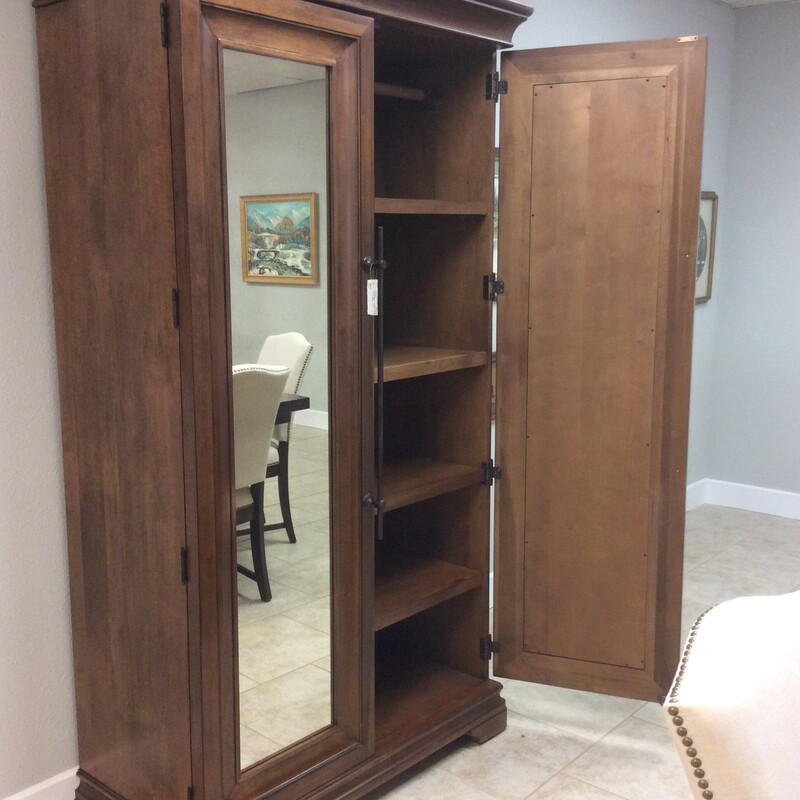 Beautifully marries traditional aesthetic with an abundance of functional storage, with two doors, two long bar pulls, and a mirrored front-detailing.  Finished with a Cognac-hued frame. Size: 48x23x82