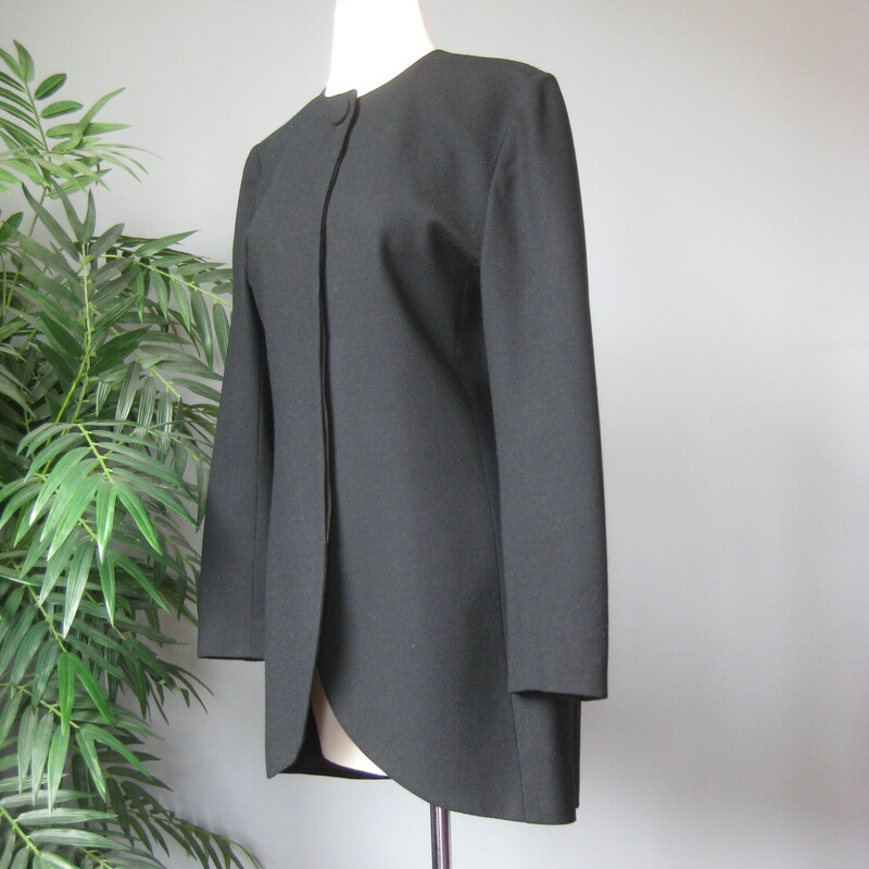 Stunning Christian Dior Blazer in black wool<br />
This blazer is a bit long as was the style in its day.<br />
Such clean lines and beautiful tailoring.<br />
One button at the neck and the rest are hidden in the placket.<br />
Fully lined in black.<br />
When I got it it has a rip in the lining at each shoulder area. I had it repaired, you can see the repairs in my last photo.<br />
Marked size 6<br />
shoulder to shoulder: 16.5<br />
armpit to armpit: 19.75<br />
waist: 17<br />
underarm sleeve seam: 16.75<br />
length: 32<br />
<br />
thanks for looking!<br />
#72706