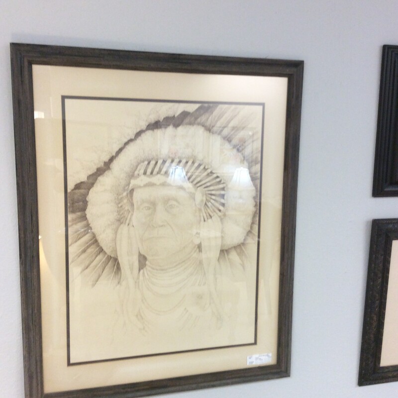 This monocramatic Indian Head print is done in sepia tones with a wood frame.