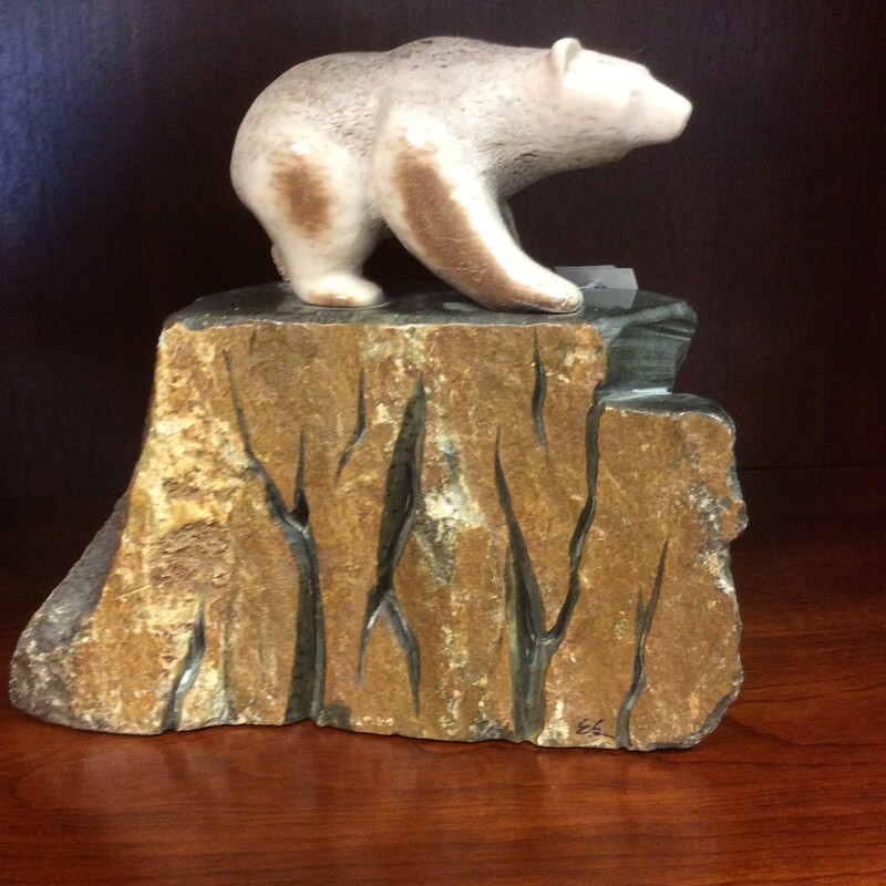 This beautiful sculpture of a Polar Bear On a Rock is done with all natural materials. The bear is carved out of bone.