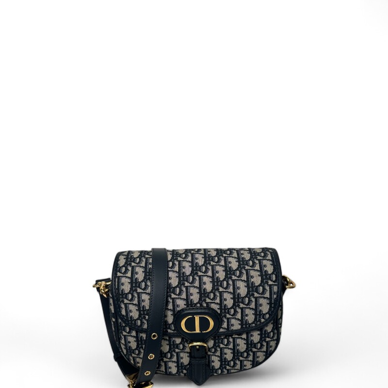 Dior Bobby bag is a hobo style showcasing sophisticated lines and harmonious proportions. The model is crafted from blue Dior Oblique jacquard and is enhanced by antique gold-finish metal hardware. Its removable and adjustable shoulder strap has a military-inspired buckle, and allows the medium bag to be carried by hand, worn over the shoulder or crossbody.
Flap closure
Magnetic clasp with decorative CD buckle
Embossed 30 Montaigne signature on the back
Back pocket
Interior patch pocket
Adjustable and removable sliding leather shoulder strap
Christian Dior military-inspired buckle
Made in Italy

Dimensions:
Dimensions:  8.5 x 6.5 x 2.5 inches
Strap length:  42 - 46 inches
Drop length:18.5 - 20.5 inches