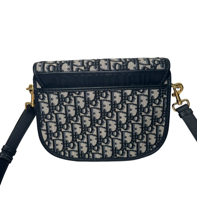 Dior Bobby bag is a hobo style showcasing sophisticated lines and harmonious proportions. The model is crafted from blue Dior Oblique jacquard and is enhanced by antique gold-finish metal hardware. Its removable and adjustable shoulder strap has a military-inspired buckle, and allows the medium bag to be carried by hand, worn over the shoulder or crossbody.<br />
Flap closure<br />
Magnetic clasp with decorative CD buckle<br />
Embossed 30 Montaigne signature on the back<br />
Back pocket<br />
Interior patch pocket<br />
Adjustable and removable sliding leather shoulder strap<br />
Christian Dior military-inspired buckle<br />
Made in Italy<br />
<br />
Dimensions:<br />
Dimensions:  8.5 x 6.5 x 2.5 inches<br />
Strap length:  42 - 46 inches<br />
Drop length:18.5 - 20.5 inches