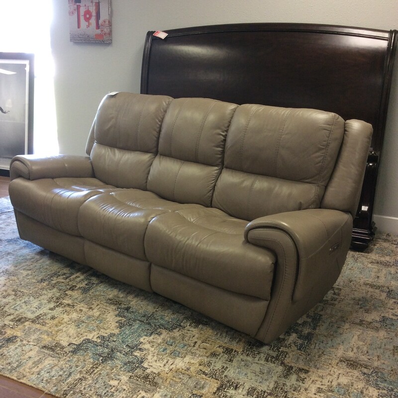 This is a gorgeous reclining sofa from Flexsteel. Upholstered in a lovely tan leather. There is a matching reclining chair priced separately.