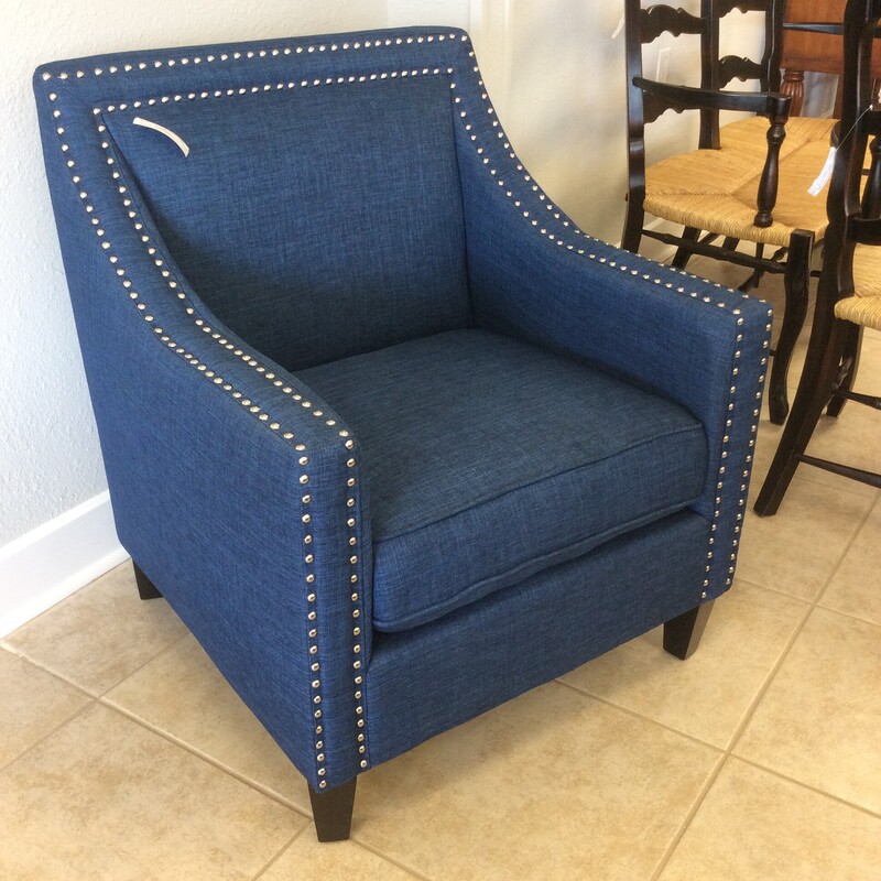 This is a very nice deep blue
 accent chair with a bold, shiny double naihead trim.