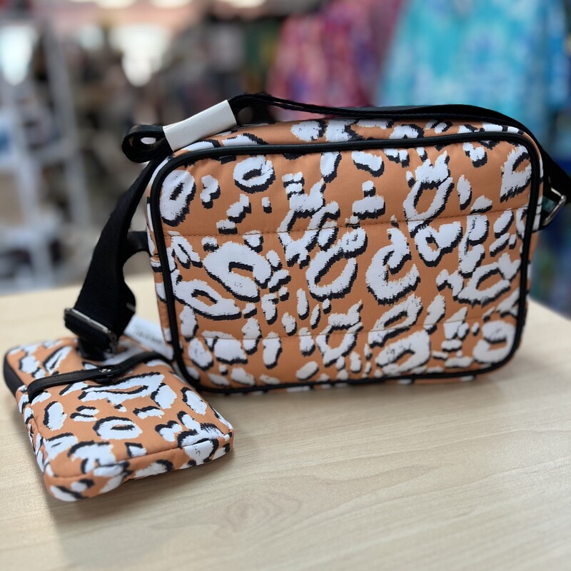 TED BAKER<br />
NWT Ted Baker Women's Niqita Leopard Detail Puffer Nylon Camera Bag<br />
Cut from recycled shell in a vibrant orange white and black leopard print, it adds a playful pop of colour to your look. The cushioned silhouette has multiple zipped pockets – including a removable pouch - for effortless organisation.<br />
Main/Lining: Recycled Polyester. Trim: Faux Leather.<br />
Dimensions: H: 16cm x W: 23cm x D: 8cm. Strap Drop: 55cm.<br />
NO marks or flaws.  New Condition!<br />
Retail Price:  $145.00