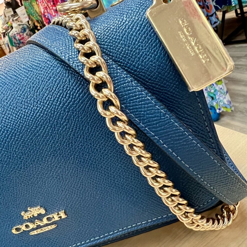 COACH<br />
Klare Crossbody Bag In Signature Canvas<br />
The Klare Crossbody is a true day-to-night favorite with a chain strap that can be worn three ways: crossbody, long or doubled up on the shoulder. An abundance of multifunction pockets keep your phone, small wallet and other essentials (like keys and lip balm) organized.<br />
Measurements:<br />
Length: 2.75\"<br />
Height: 8.5\"<br />
Width: 6.25\"<br />
Materials:<br />
Crossgrain leather and signature coated canvas<br />
Fabric lining<br />
Strap:<br />
Strap with 22\" drop doubles up for three ways to wear: short or long on the shoulder or crossbody style<br />
Features:<br />
Outside slip pocket<br />
Inside zip pocket<br />
Snap closure<br />
Inside multifunction pocket<br />
Original Retail Price:  $398.00<br />
This bag is in like new condition.  No marks or flaws.