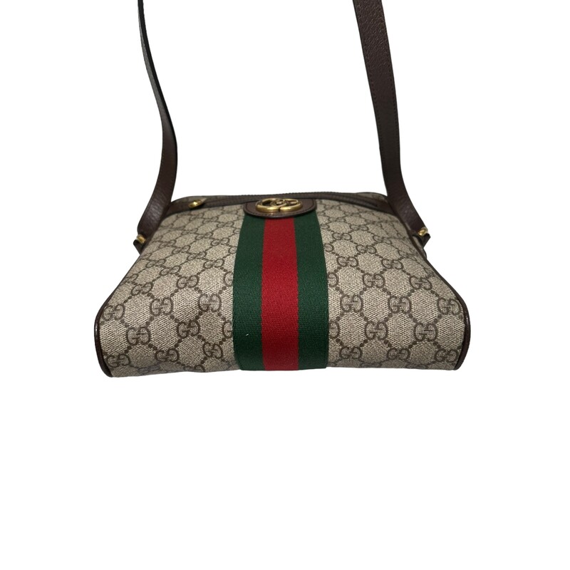 Gucci  Ophidia
Beige/ebony GG Supreme canvas, with brown leather trim
Green and red Web
Antique gold-toned hardware
Interior open pocket
Double G
Front zipper pocket
Interior zipper pocket
Adjustable leather shoulder strap with 21.5 drop
Zipper closure
Small size: 9W x 9.5H x 2D
Made in Italy