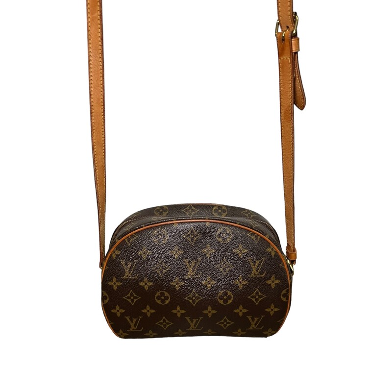 LOUIS VUITTON Monogram Blois. This stylish crossbody is crafted of traditional Louis Vuitton monogram on toile coated canvas in a feminine oval silhouette. The shoulder bag features a lengthy vachetta cowhide leather shoulder strap with brass hardware and a full wide facing pocket with a vachetta trim. The top zipper opens to a spacious terra-cotta cross-grained leather interior with a patch pocket.<br />
Dimensions:<br />
Length: 9.5 in<br />
Height: 7 in<br />
Width: 4.5 in<br />
Drop: 16 in