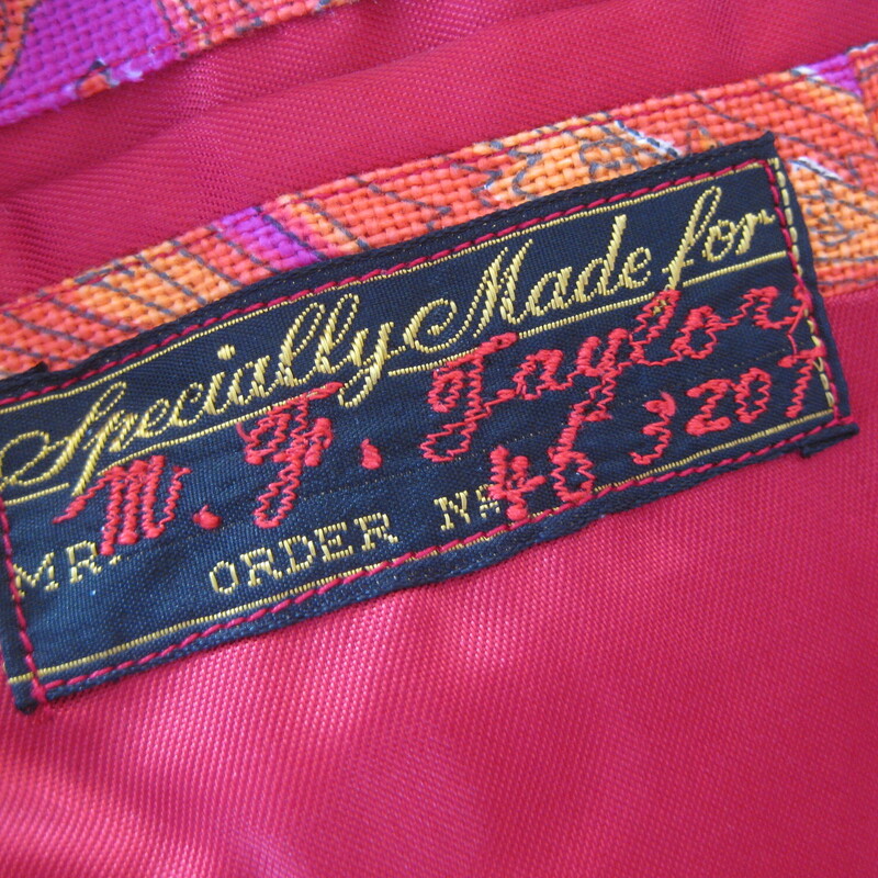 For Cool Girls or Guys<br />
This blazer was made in 1966 for an American serviceman stationed in Japan.<br />
Fabulous orange and magenta paisleyy fabric, which feels like a substantial woven cotton.<br />
Beautifully tailored with interior pockets, a little bit of padding at the upper back and lovely touches, like the finish on the exterior pockets.<br />
It's furnished with flat gold buttons and there is a spare of each type (one of rhte cuffs and one for the front closures) on the inside.<br />
It's double breasted with two flaps at the back and high peaked lapels<br />
The man it was made for was not a big man. My mannequin is about a modern mens size medium and it is a little snug on him.<br />
This jacket would work for a woman or a man. I am 5' 5, about a modern size 8 on top and it is only a smidge too big for me. I would totally wear it.<br />
<br />
No size tag, here are the Flat Measurements:<br />
<br />
Armpit to Armpit: 20.25, measured on the inside<br />
Length (back of neck to hem): 29.75<br />
waist area: 18.5<br />
Length of underarm sleeve seam: just under 18<br />
Width at hem area while lying flat and buttoned: 19<br />
Length: 31<br />
Any questions about fit? please get in touch I can help!<br />
<br />
Excellent condition! No flaws.<br />
<br />
Thank you for looking.<br />
#75098