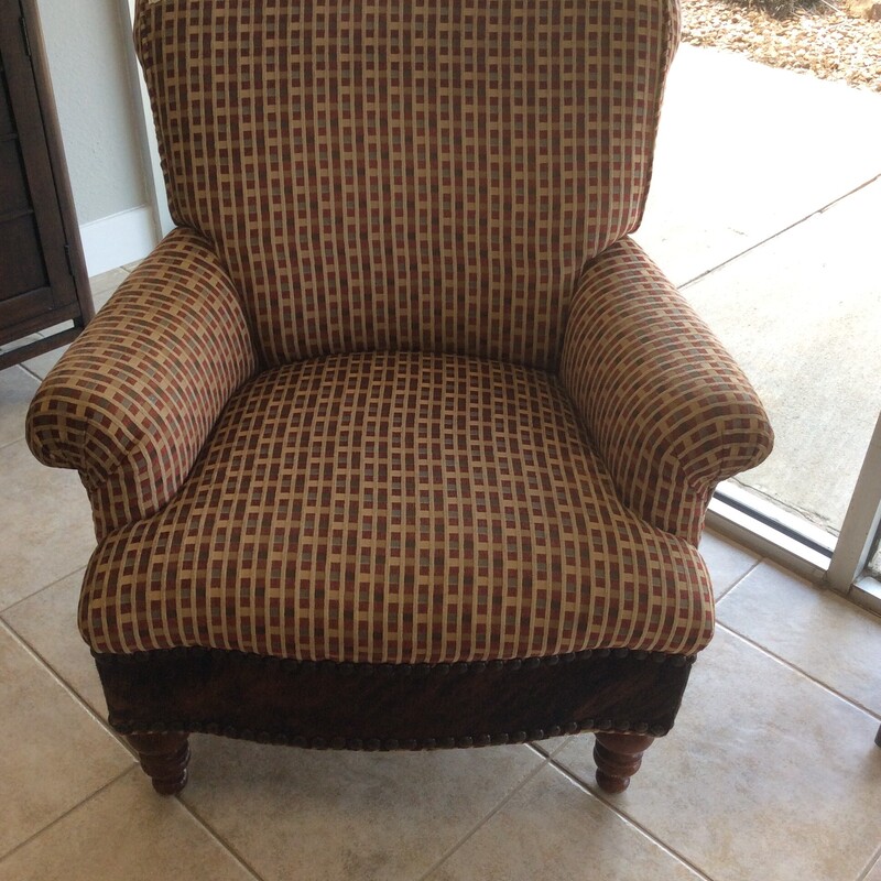 Red/Gold colored upholstered chair with a cowhide accented with nail heads around the front bottom.