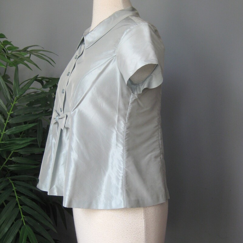 Very beautiful and high end looking short sleeve blouse by Moschino.<br />
Pale Pale slightly gray bloue.<br />
100% silk<br />
Made in Italy<br />
Should fit an XS petite nicely.<br />
The blouse buttons down from the neck to about the waist area.<br />
<br />
flat measurements:<br />
shoulder to shoulder: 13.25 (quite narrow here)<br />
armpit to armpit: 17.5<br />
waist area: 17.5<br />
length: 22<br />
excellent condition!  no flaws<br />
<br />
Thanks for looking!<br />
#73067