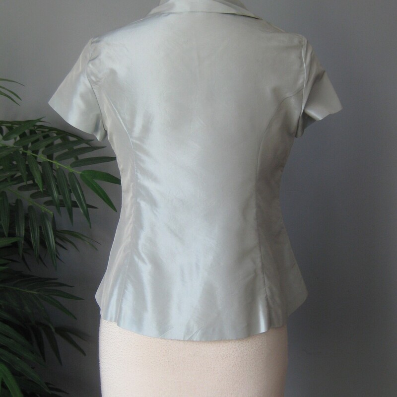 Very beautiful and high end looking short sleeve blouse by Moschino.<br />
Pale Pale slightly gray bloue.<br />
100% silk<br />
Made in Italy<br />
Should fit an XS petite nicely.<br />
The blouse buttons down from the neck to about the waist area.<br />
<br />
flat measurements:<br />
shoulder to shoulder: 13.25 (quite narrow here)<br />
armpit to armpit: 17.5<br />
waist area: 17.5<br />
length: 22<br />
excellent condition!  no flaws<br />
<br />
Thanks for looking!<br />
#73067