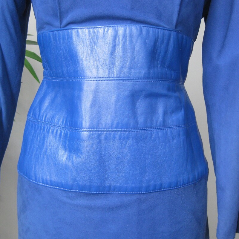 Vtg Vakko Suede, Royal Bl, Size: 10<br />
Stunning! Softest kid suede dress. Royal blue with leather wide corset band at waist.<br />
Slim Pencil skirt<br />
long sleeves<br />
Bustly peplum at the low cut open back.<br />
A suede band at the back of the neck.<br />
Fully Lined.<br />
Shoulder pads inside lining.<br />
The suede and leather is of the very high quality which Vakko is known for.<br />
<br />
CONDITION: Excellent condition with very minor fading at the left seam, probably where it was exposed to light in it's former closet. Also one dark spot on the back. Also, the lining is discolored in some areas from the former wearer's body.<br />
<br />
LABEL: Vakko, made USA<br />
SIZE: Marked size 10, BUT it fits much smaller. Fits like a modern smallish size 4.<br />
PLEASE see measurements provided and compare to a similar garment of your own, allow an inch or so for differences in measuring techniques. Reach out if you need help, I'm good at helping people figure out fit! :)<br />
<br />
Flat measurements:<br />
Shoulder to shoulder: 17<br />
Armpit to armpit - about 15.75 (bc of the construction of the dress with cut on sleeves, it's a little hard to get an accurate here. I wouldn't worry too much about this measurement unless you are very large busted.)<br />
Waist, flat at center of leather - about 14.<br />
Hip: 19.25<br />
Vent is about 6<br />
Underarm sleeve seam:- about 17<br />
Length : 44<br />
<br />
thanks for looking!<br />
#71243