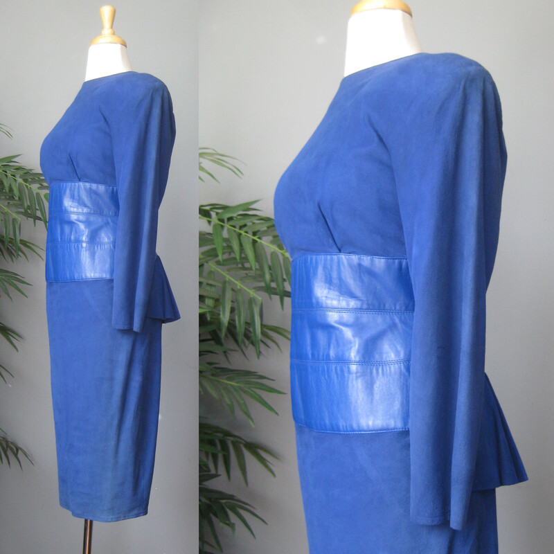 Vtg Vakko Suede, Royal Bl, Size: 10<br />
Stunning! Softest kid suede dress. Royal blue with leather wide corset band at waist.<br />
Slim Pencil skirt<br />
long sleeves<br />
Bustly peplum at the low cut open back.<br />
A suede band at the back of the neck.<br />
Fully Lined.<br />
Shoulder pads inside lining.<br />
The suede and leather is of the very high quality which Vakko is known for.<br />
<br />
CONDITION: Excellent condition with very minor fading at the left seam, probably where it was exposed to light in it's former closet. Also one dark spot on the back. Also, the lining is discolored in some areas from the former wearer's body.<br />
<br />
LABEL: Vakko, made USA<br />
SIZE: Marked size 10, BUT it fits much smaller. Fits like a modern smallish size 4.<br />
PLEASE see measurements provided and compare to a similar garment of your own, allow an inch or so for differences in measuring techniques. Reach out if you need help, I'm good at helping people figure out fit! :)<br />
<br />
Flat measurements:<br />
Shoulder to shoulder: 17<br />
Armpit to armpit - about 15.75 (bc of the construction of the dress with cut on sleeves, it's a little hard to get an accurate here. I wouldn't worry too much about this measurement unless you are very large busted.)<br />
Waist, flat at center of leather - about 14.<br />
Hip: 19.25<br />
Vent is about 6<br />
Underarm sleeve seam:- about 17<br />
Length : 44<br />
<br />
thanks for looking!<br />
#71243