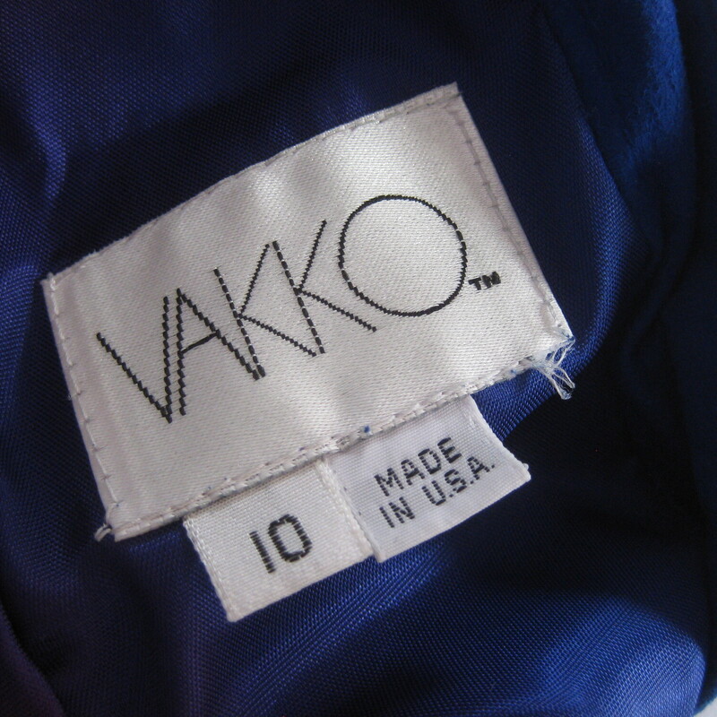 Vtg Vakko Suede, Royal Bl, Size: 10<br />
Stunning! Softest kid suede dress. Royal blue with leather wide corset band at waist.<br />
Slim Pencil skirt<br />
long sleeves<br />
Bustly peplum at the low cut open back.<br />
A suede band at the back of the neck.<br />
Fully Lined.<br />
Shoulder pads inside lining.<br />
The suede and leather is of the very high quality which Vakko is known for.<br />
<br />
CONDITION: Excellent condition with very minor fading at the left seam, probably where it was exposed to light in it's former closet. Also one dark spot on the back. Also, the lining is discolored in some areas from the former wearer's body.<br />
<br />
LABEL: Vakko, made USA<br />
SIZE: Marked size 10, BUT it fits much smaller. Fits like a modern smallish size 4.<br />
PLEASE see measurements provided and compare to a similar garment of your own, allow an inch or so for differences in measuring techniques. Reach out if you need help, I'm good at helping people figure out fit! :)<br />
<br />
Flat measurements:<br />
Shoulder to shoulder: 17<br />
Armpit to armpit - about 15.75 (bc of the construction of the dress with cut on sleeves, it's a little hard to get an accurate here. I wouldn't worry too much about this measurement unless you are very large busted.)<br />
Waist, flat at center of leather - about 14.<br />
Hip: 19.25<br />
Vent is about 6<br />
Underarm sleeve seam:- about 17<br />
Length : 44<br />
<br />
thanks for looking!<br />
#71243