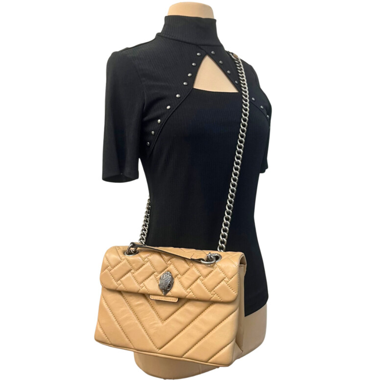 Kurt Geiger Kensington Handbag<br />
Quilted with Chain Strap<br />
2 Magnetic Snap Closures and Interior Wall Pocket<br />
Eagle Head Jewel Detail for Closure<br />
100% Leather<br />
Color: Warm Beige