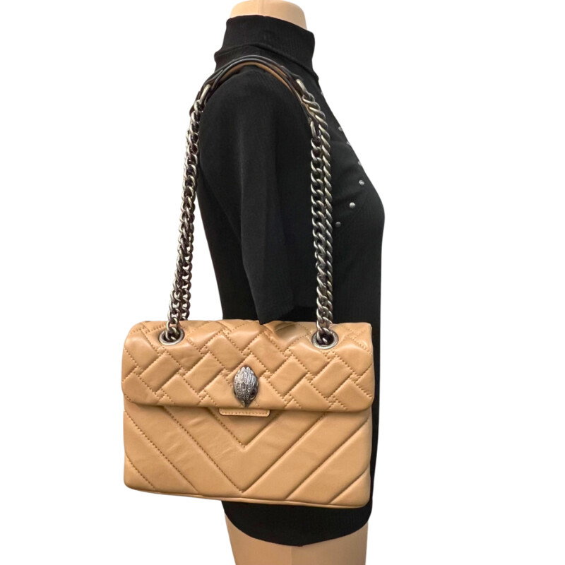 Kurt Geiger Kensington Handbag<br />
Quilted with Chain Strap<br />
2 Magnetic Snap Closures and Interior Wall Pocket<br />
Eagle Head Jewel Detail for Closure<br />
100% Leather<br />
Color: Warm Beige