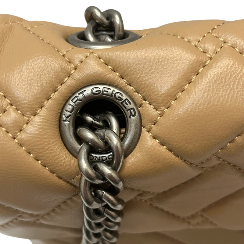 Kurt Geiger Kensington Handbag<br />
Quilted with Chain Strap<br />
2 Magnetic Snap Closures and Interior Wall Pocket<br />
Eagle Head Jewel Detail for Closure<br />
100% Leather<br />
Color: Warm Beige