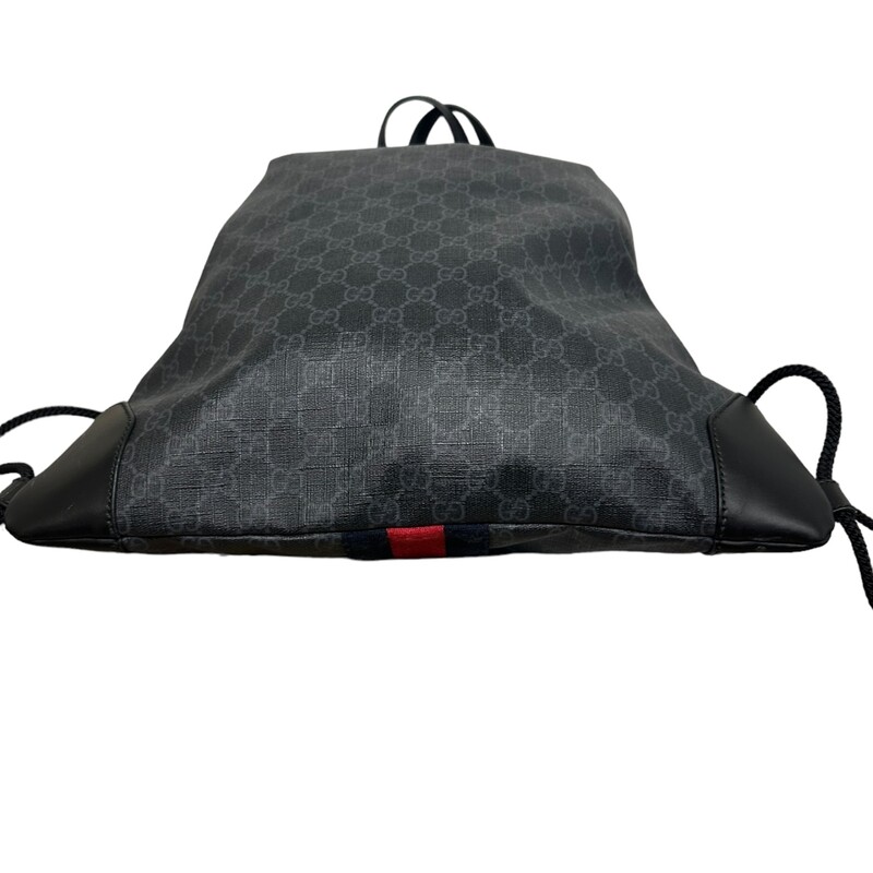 GUCCI Soft GG Supreme Monogram Appia Calfskin Web Drawstring Backpack in Black. This stylish backpack is crafted of Gucci GG monogram coated canvas with black leather corners. The shoulder bag features black leather top handles and interior trim, and black side cable cording. This side cording gathers around the top to cinch the backpack closed and opens to a spacious black nylon fabric interior with a zipper pocket.<br />
Dimensions:<br />
Base length: 15 in<br />
Height: 17.75 in<br />
Width: 0.75 in<br />
Drop: 3 in<br />
Drop: 18 in