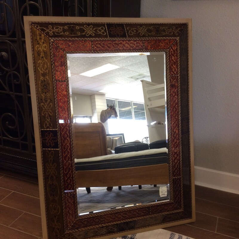 This Beveled Mirror from Bombay Co. has a reverse painted glass frame with gold leaf trim.
