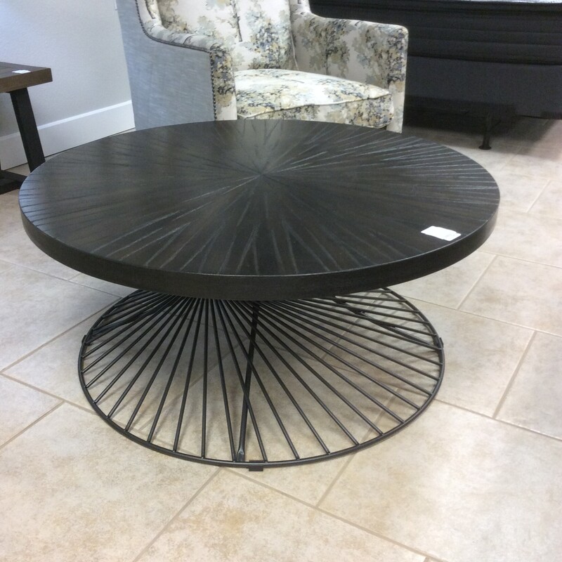 This 40 inch round Coffee Table has a wood top with a black metal base.