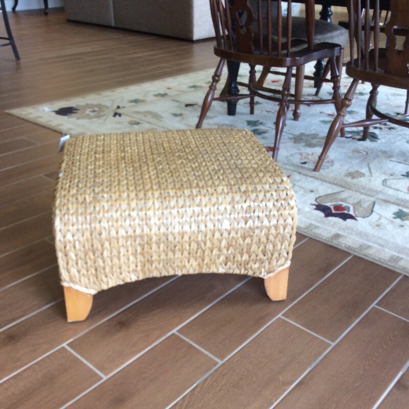 This Ottoman made from woven seagrass with wooden legs.