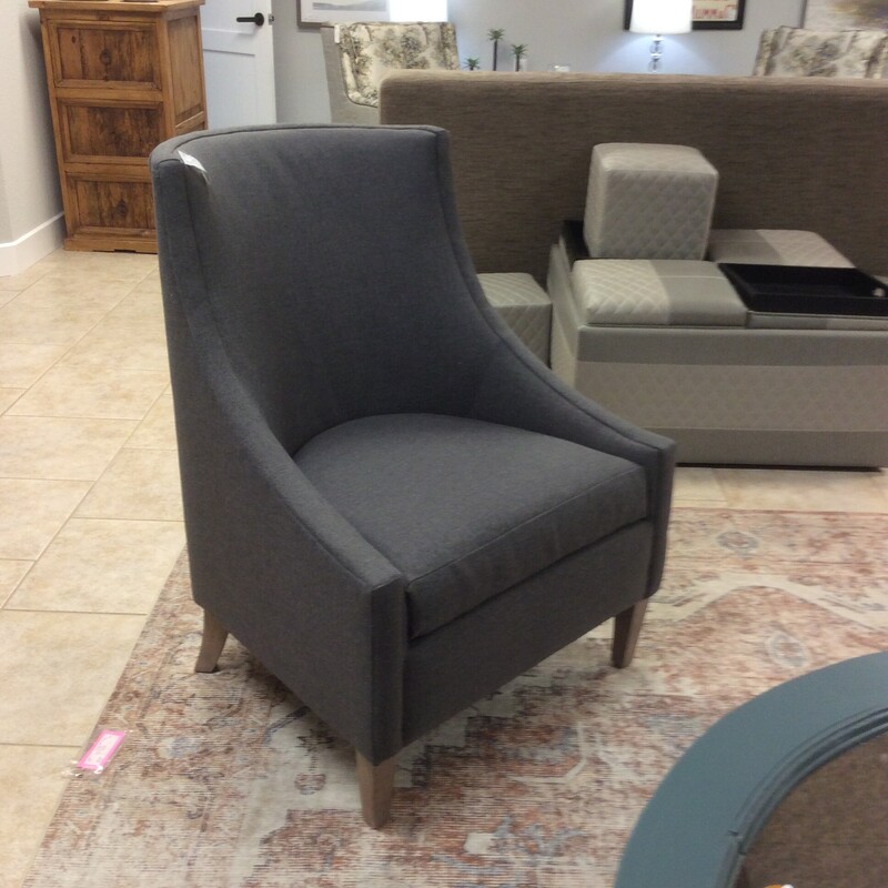 This versatile Chair is upholtered in a solid Gray fabric.