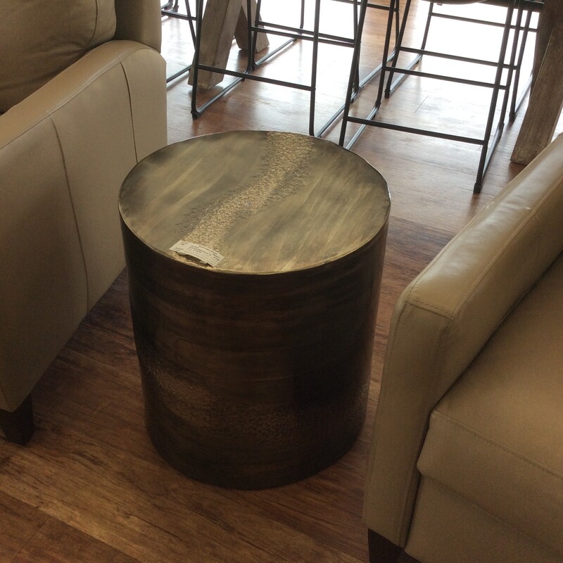 This Metal Drum Table from Riverside Furniture has an antiqued brass finish.