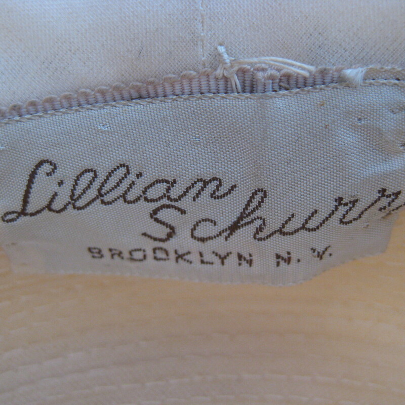 Vtg Lillian Shur Folded, Ivory, Size: None<br />
understated but fancy summer hat in ivory folded silk with a little brim covered with a net.<br />
Finished with a matching velvet ribbon and sparkling jewel.<br />
<br />
1950s By Lillian Shurr in Brooklyn NY<br />
<br />
Inner hat band measures 20 1/4<br />
Excellent vintage condition!<br />
thanks for looking!<br />
#61740