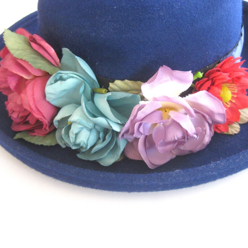 Wool felt hat with bit of brim and romantic colorful fabric flowers and wide ribbon.<br />
Made in the USA<br />
<br />
Excellent vintage condition!<br />
<br />
This hat is a little big for my mannequin, she has a small head, this should fit a medium to large womans head nicely.<br />
<br />
Inner hat band: 21.5<br />
<br />
Thanks for looking!<br />
#76836