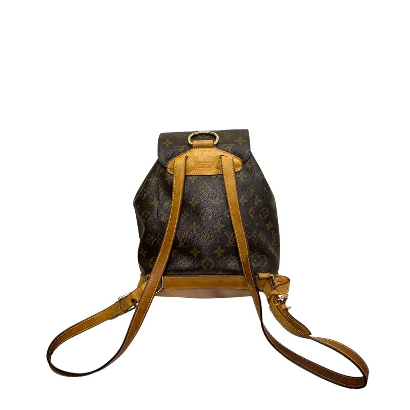 LOUIS VUITTON Monogram Montsouris Backpack. This versatile backpack is crafted of classic monogram coated canvas. The bag features a front zipper pocket, and natural vachetta cowhide leather trim including the base, top handle, and adjustable backpack straps. The bag opens with a belt buckle to a cocoa brown fabric interior.<br />
<br />
Dimensions:<br />
Base length: 8 in<br />
Height: 9 in<br />
Width: 4 in<br />
Drop: 2 in<br />
Drop: 14 in<br />
<br />
Code: SP0020