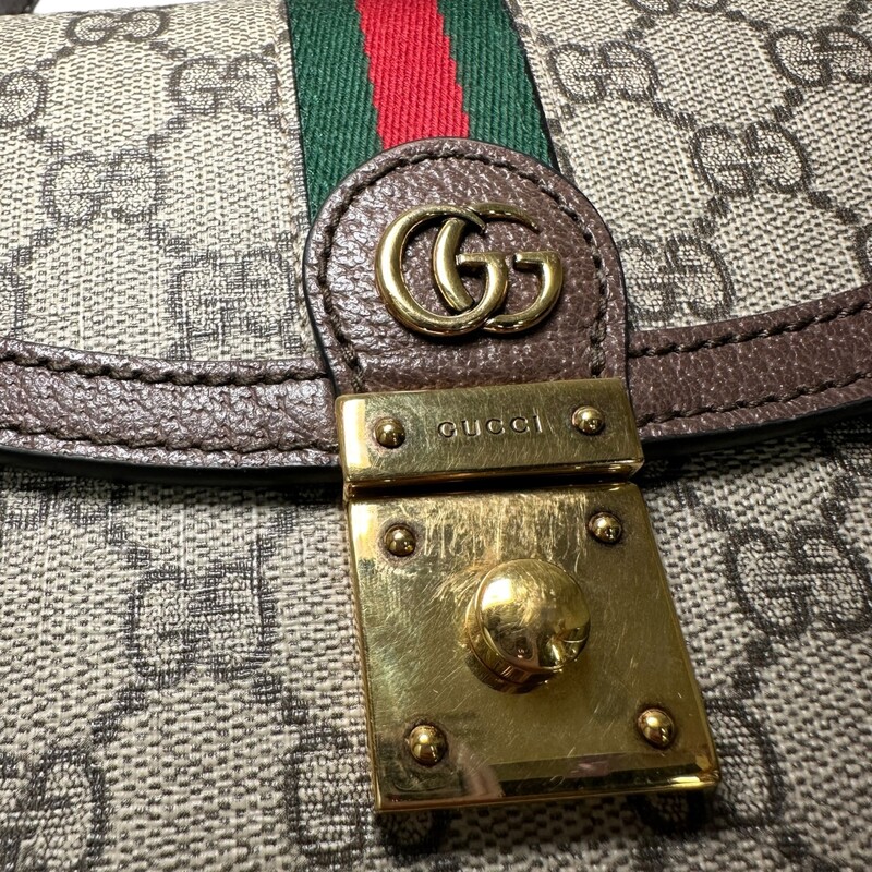 Gucci Ophidia Top Handle, Monogram Crossbody<br />
Beige and ebony GG Supreme canvas<br />
Brown leather trim<br />
Shiny gold-toned hardware<br />
Green and red House Web<br />
Microfiber lining with suede-like finish<br />
Inserts contain leather made through an alternative metal or chrome free tanning process, reducing the environmental footprint compared to traditional methods.<br />
Double G<br />
Internal: zip pocket and open pocket<br />
Strap length: 36.2 - 40.2<br />
Handle with 4 drop<br />
Detachable and adjustable shoulder strap drop: 18.1 - 20.5<br />
Magnetic closure<br />
Made In italy<br />
<br />
Dimensions:<br />
 9.8W x 6.9H x 2.8D<br />
<br />
*Some minor marks on hardware