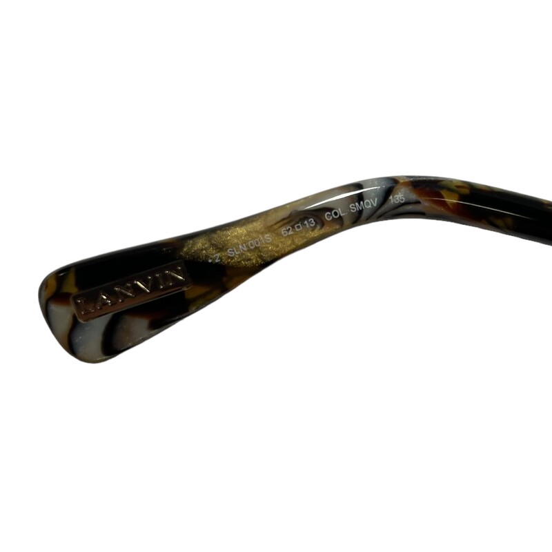 Lanvin SLN001 Textured<br />
<br />
Reptile Scales Framed Sunglasses<br />
Lenses have a gradient tint that starts dark at the top and gradually lightens towards the bottom<br />
The length of the temple pieces are 135 millimeters<br />
The width of the bridge of this frame is 13 millimeters<br />
The lens are 62 millimeters at the largest point<br />
Compatible with bi-focal, progressive lenses, or prescription lens installation<br />
Composed of metal like nickel, monel, or stainless steel to help give some durability and relative overall strength<br />
Fully rimmed along the edges<br />
<br />
Please Note: there are some faint, minor scratches on the lens