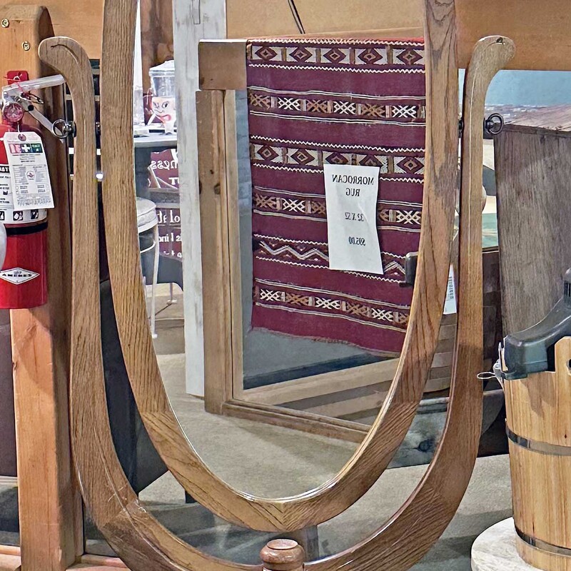 Standing Mirror,
 Size: 28 X 63
This mirror is 48 inches tall and 63 inches tall when placed on the base.  It is in good condition and swivels to adjust the angle.  It is framed in oak and has an oak pedestal style base.