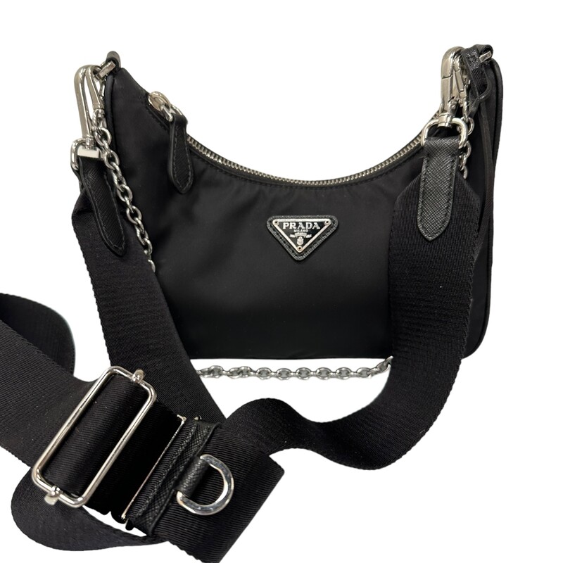 Prada Re Edition Nylon 2005 Black Crossbody<br />
<br />
Dimensions:<br />
Height: 18cm<br />
Width: 22cm<br />
Length: 6cm<br />
<br />
Factory Code: 7/D<br />
<br />
Note: small rip on inteior by the tag, does not come with small pouch.