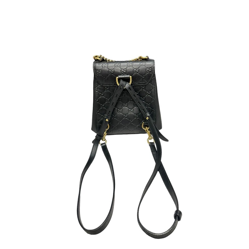 GUCCI Guccissima Signature Padlock Backpack in Black. This stylish tote is crafted of Gucci GG monogram calfskin leather in black. The shoulder bag features gold-tone hardware, adjustable black leather shoulder straps, and opens to a rose beige suede interior with patch pockets.<br />
<br />
Dimensions:<br />
Base length: 8.25 in<br />
Height: 8 in<br />
Width: 3.5 in<br />
Drop: 2 in<br />
Drop: 12.5 in<br />
<br />
Style Code:498194<br />
<br />
Some marks on hardware