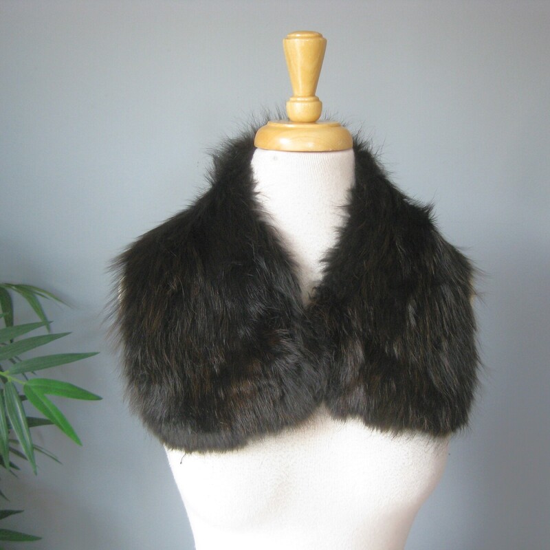 This is a simple black fur collar that probably came from a 1950s coat. It's really nicely made and in great condition and ready to be attached to a new coat! You could also pin it around the base of your neck using the existing hook and eye closure. Add it to a simple crew neck top or sweater for a touch a warm and luxury. Or wear on your bare skin above a strapless bodice, it will feel fabulous and lend an air of uniqueness to your high fashion looks.

The fur is long and luxurious. very soft. It's not mink - no guard hairs, it'snot rabbit either, too long.... dyed fox - I think it might be too soft even for fox.

It measure aproximately 22 along the top edges where the hook and eye closure is end to end of the satin lining on the underside. So it will sit high on the neck pretty similar to how you see it on the dress form.

It's made of a very dark fur, reads black but has brown dimension
excellent condition, no shedding, fresh and soft
Thank you for looking!
#71616