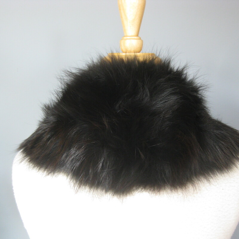 This is a simple black fur collar that probably came from a 1950s coat. It's really nicely made and in great condition and ready to be attached to a new coat! You could also pin it around the base of your neck using the existing hook and eye closure. Add it to a simple crew neck top or sweater for a touch a warm and luxury. Or wear on your bare skin above a strapless bodice, it will feel fabulous and lend an air of uniqueness to your high fashion looks.<br />
<br />
The fur is long and luxurious. very soft. It's not mink - no guard hairs, it'snot rabbit either, too long.... dyed fox - I think it might be too soft even for fox.<br />
<br />
It measure aproximately 22 along the top edges where the hook and eye closure is end to end of the satin lining on the underside. So it will sit high on the neck pretty similar to how you see it on the dress form.<br />
<br />
It's made of a very dark fur, reads black but has brown dimension<br />
excellent condition, no shedding, fresh and soft<br />
Thank you for looking!<br />
#71616