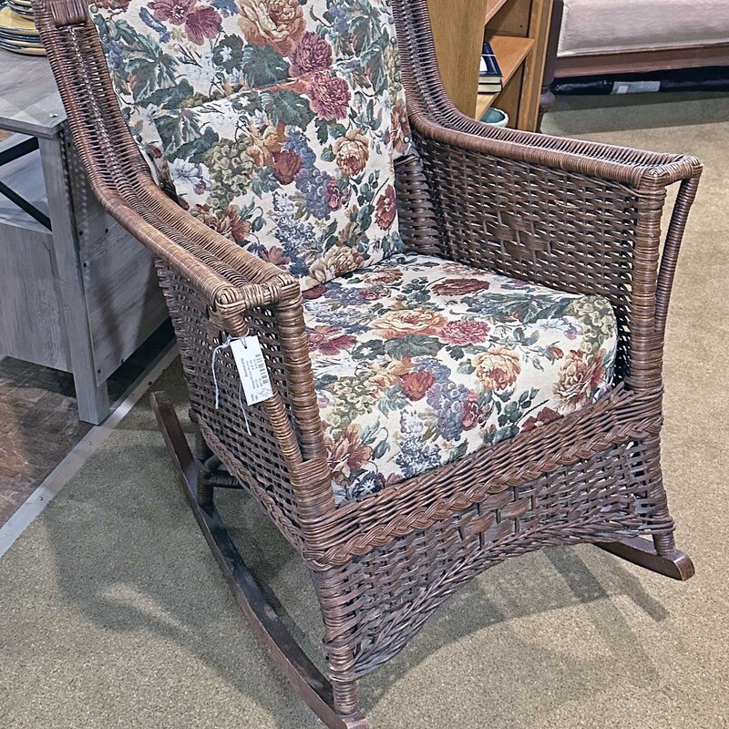 Antique Dark Brown Wicker Rocker
with Floral Padding and Pillow
23 In Wide x 35 In Deep x 34 In Tall.