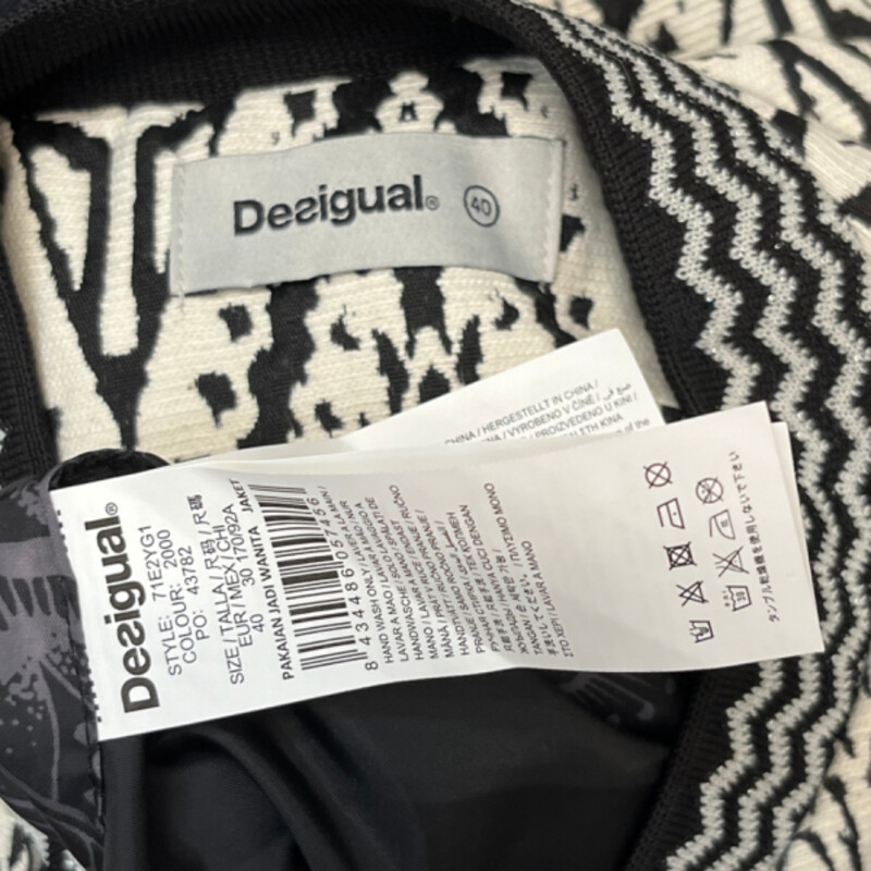 Desigual Woven Jacket<br />
Absolutely Stunning!<br />
Embroidered Floral Detail<br />
Arm Banding Detail<br />
Embroidered Flower On Back<br />
Lined with Floral Lining<br />
No Detail Missed on This One!<br />
Black and White with a rainbow of Colors<br />
Size: 10