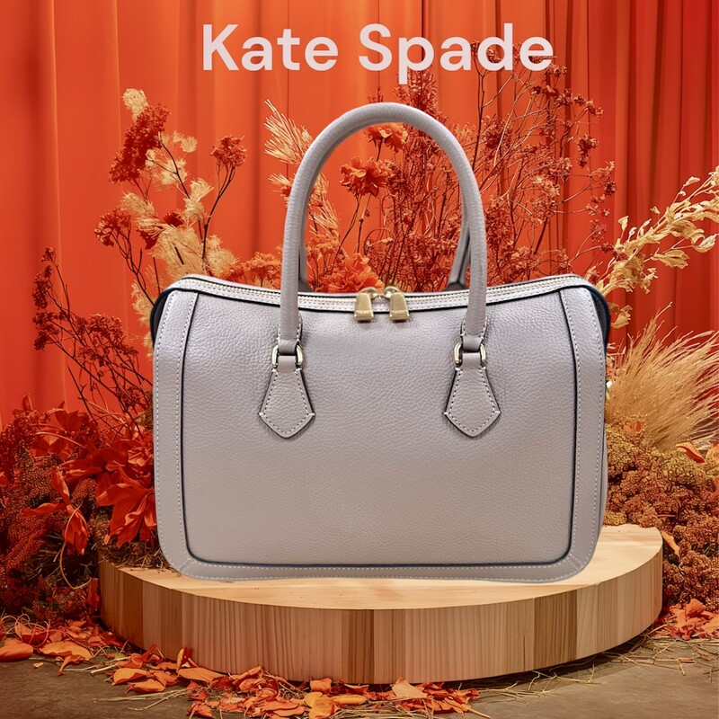 Kate Spade Gramercy Satchel Bag<br />
Designed for a structured silhouette in soft pebbled leather, our Gramercy satchel is perfect for adding a polished touch to your look.<br />
Original MSRP: $448.00<br />
Color: Kraft Paper<br />
7.75\"H x 11.75\"W x 6\"D<br />
Handle drop: 5\"<br />
Strap drop: 22\"<br />
Pebbled leather with smooth leather trim?<br />
Microsuede lining<br />
Plaque logo<br />
Satchel with zip-top closure<br />
Interior slip pocket<br />
Interior zip pocket<br />
Optional (and adjustable) shoulder/crossbody strap<br />
This bag is in like new condition, no marks or flaws