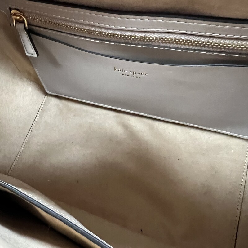 Kate Spade Gramercy Satchel Bag<br />
Designed for a structured silhouette in soft pebbled leather, our Gramercy satchel is perfect for adding a polished touch to your look.<br />
Original MSRP: $448.00<br />
Color: Kraft Paper<br />
7.75\"H x 11.75\"W x 6\"D<br />
Handle drop: 5\"<br />
Strap drop: 22\"<br />
Pebbled leather with smooth leather trim?<br />
Microsuede lining<br />
Plaque logo<br />
Satchel with zip-top closure<br />
Interior slip pocket<br />
Interior zip pocket<br />
Optional (and adjustable) shoulder/crossbody strap<br />
This bag is in like new condition, no marks or flaws