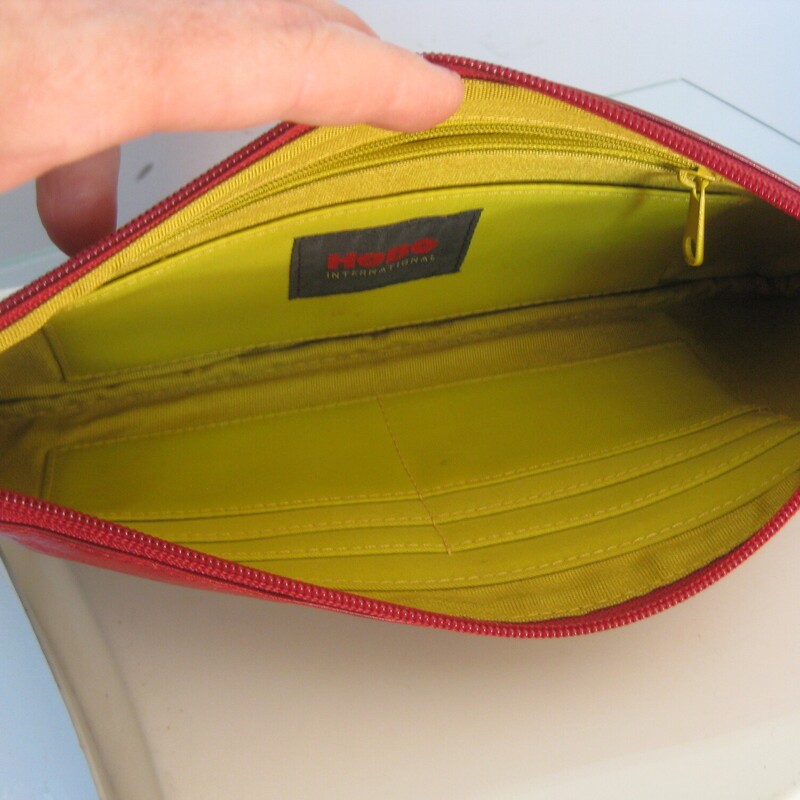 HOBO Zip Clutch, Red, Size: None<br />
smart and simple top zip wristlet from Hobo International<br />
bright red with silver hardware<br />
acid lime/yellow interior with two compartments, and leather card slots.<br />
Excellent pre-owned condition.  only flaw is some marks from makeup inside one of the interior pockets.<br />
<br />
11 x 5<br />
thanks for looking!<br />
#74973