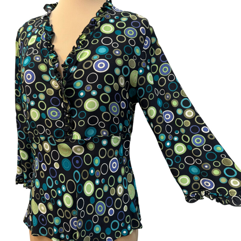 Loco Lindo Ruffled Blouse<br />
100% Rayon<br />
Ruffled neckline and sleeve hem<br />
Colors:Black with Lots of Colorful Dots<br />
Size: Medium