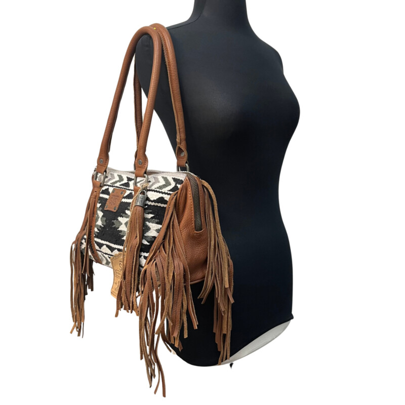 NEW Serape Choula Bag<br />
Genuine leather peiced woven serape purse<br />
The greater the storm, the brighter your rainbow. interior graphic<br />
Zipper closure<br />
Fringe trim and tassle details<br />
Compact/sub-compact interior carry holster<br />
Colors: Black, White, brown<br />
Dimension: 12 1/2 (L) x 5 (W) x 8 1/2 (H)